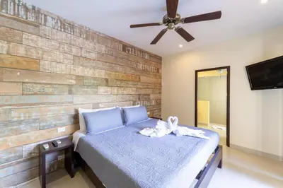 a bedroom with a bed and a ceiling fan at Casa Harmonia- 2 Br House With Pool in Potrero