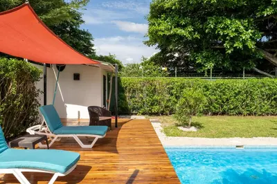 a patio with two chairs and a swimming pool at Casa Harmonia- 2 Br House With Pool in Potrero