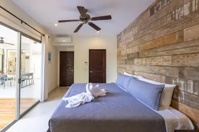 a bedroom with a bed with a dog on it at Casa Harmonia- 2 Br House With Pool in Potrero
