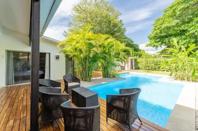 a group of chairs sitting on a deck next to a swimming pool at Casa Harmonia- 2 Br House With Pool in Potrero