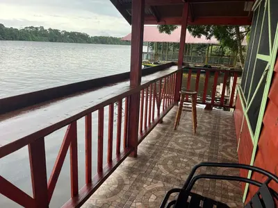a porch of a resort with a view of the water at Cabinas Tortuguero Sports Fishing in Tortuguero