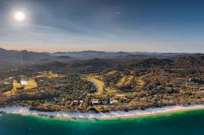 an aerial view of a beach and the ocean at Adults Only 3BR Condo with Partial Ocean View - Carao - Reserva Conchal in Playa Conchal