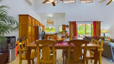 a kitchen and dining room with a table and chairs at Casa Tropical, Spacious 3 Bedroom Home in Brasilito