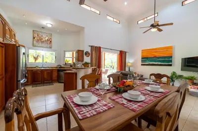 a dining room and kitchen with a table and chairs at Casa Tropical, Spacious 3 Bedroom Home in Brasilito