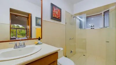 a bathroom with a sink and a shower at Casa Tropical, Spacious 3 Bedroom Home in Brasilito