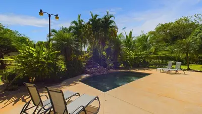 a patio with chairs and a swimming pool at Casa Tropical, Spacious 3 Bedroom Home in Brasilito