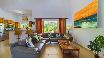 a living room with a couch and a table at Casa Tropical, Spacious 3 Bedroom Home in Brasilito
