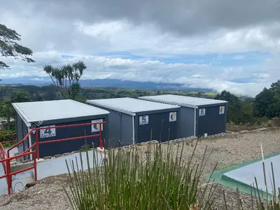a row of portable toilets sitting on top of a hill at Hotel Hospedaje Alto Lechuza Zarcero in Zarcero