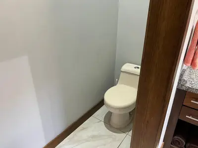 a bathroom with a white toilet in a room at Casa Famari at Playa Bejuco in Bejuco