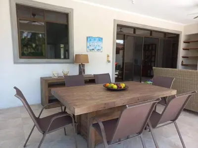 a dining room table with chairs and a bowl of fruit on it at Casa Famari at Playa Bejuco in Bejuco