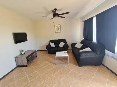 a living room with a couch and a tv at JFM Apartamento in Coco