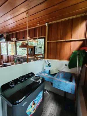 a kitchen with a stove and a table in it at Gambas Lodge in Fortuna