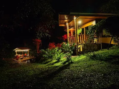 a house with lights on the side of it at night at Gambas Lodge in Fortuna