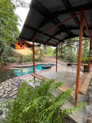 a pavilion with a swimming pool in a yard at Gambas Lodge in Fortuna