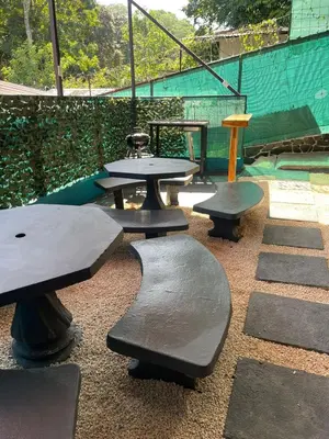 a group of tables and benches in a park at Casa Eli en Playa Manuel Antonio in Quepos