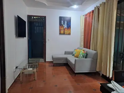 a living room with a couch and a table at Casa Eli en Playa Manuel Antonio in Quepos
