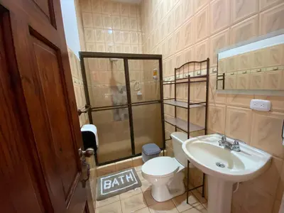 a small bathroom with a sink and a toilet at Casa Eli en Playa Manuel Antonio in Quepos