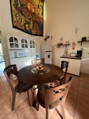 a dining room table and chairs in a kitchen at Mariposa End Unit Loft in Coco