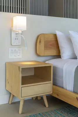 a bedroom with a bed with a nightstand and a lamp at New Beachfront House - Casa Aura in Santa Teresa Beach