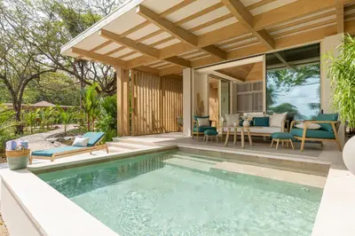 a swimming pool in a backyard with a house at New Beachfront House - Casa Aura in Santa Teresa Beach