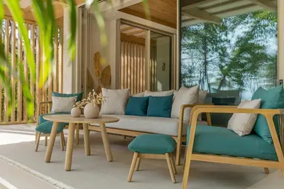 a living room with a couch and a table and chairs at New Beachfront House - Casa Aura in Santa Teresa Beach