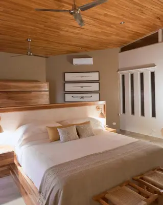 a bedroom with a large bed with a wooden ceiling at Vista Celestial in Uvita