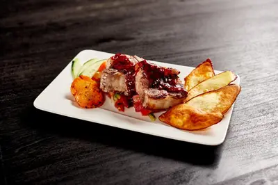 a plate of food with meat and chips on a table at Vista Celestial in Uvita
