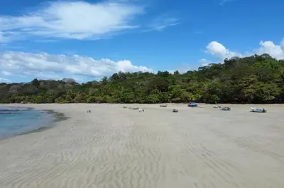 a beach with boats sitting on the sand at Casa Mar 2 Manzanillo St Teresa in Boca de Ario