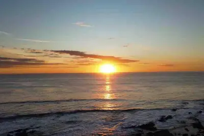a sunset over the ocean with the sun setting at Casa Mar 2 Manzanillo St Teresa in Boca de Ario