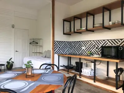 a room with a table and chairs and a bedroom at Casa Mar 2 Manzanillo St Teresa in Boca de Ario