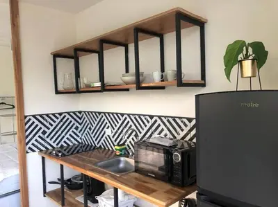 a microwave sitting on top of a wooden table at Casa Mar 2 Manzanillo St Teresa in Boca de Ario