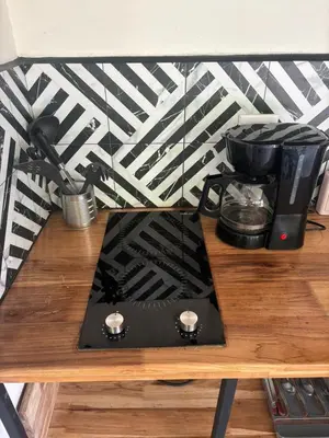 a coffee maker on top of a wooden table at Casa Mar 2 Manzanillo St Teresa in Boca de Ario