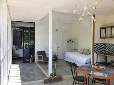 a bedroom with a bed and a table and chairs at Casa Mar 2 Manzanillo St Teresa in Boca de Ario