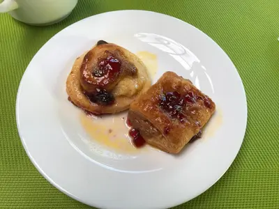 a white plate with two pastries on a table at Tamarindo Village Hotel in Tamarindo