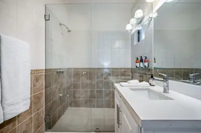 a bathroom with a shower and a sink and a mirror at Villas Catalina 7 in Potrero