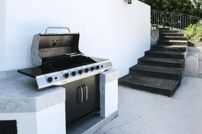 a barbecue grill on a patio next to a staircase at Villas Catalina 7 in Potrero