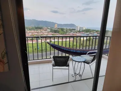a balcony with a hammock and a table and chair at Jaco Bay 4903 Three bdrm Suite Spectacular Views Pool in Jacó