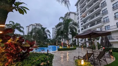 a hotel courtyard with a swimming pool and buildings at Jaco Bay 4903 Three bdrm Suite Spectacular Views Pool in Jacó