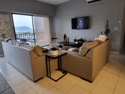 a living room with a couch and a tv at Jaco Bay 4903 Three bdrm Suite Spectacular Views Pool in Jacó