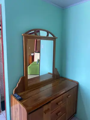 a wooden dresser with a mirror on top of it at HOSTEL CASA MARINA in Puerto Limón