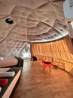 a room with a tent with a bed and a chair at Glamping en Playa Potrero in Potrero