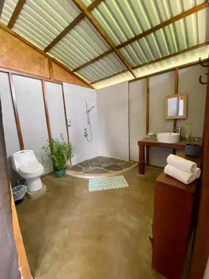 a large bathroom with a toilet and a sink at Hacienda Monteclaro in Turrialba