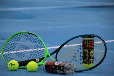 two tennis rackets and tennis balls on a court at Family 2bd apt near Quepos/Manuel Antonio in Quepos