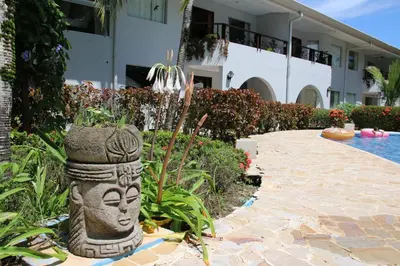 a stone statue in front of a building at Family 2bd apt near Quepos/Manuel Antonio in Quepos