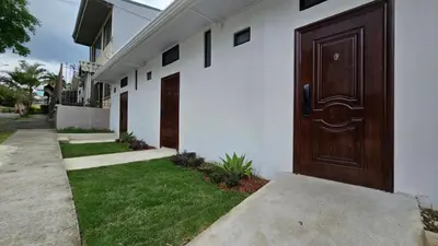 a building with a brown door on the side of it at EcoStudio in San José