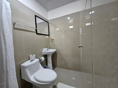 a bathroom with a toilet and a glass shower at EcoStudio in San José