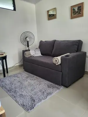 a living room with a couch and a rug at EcoStudio in San José