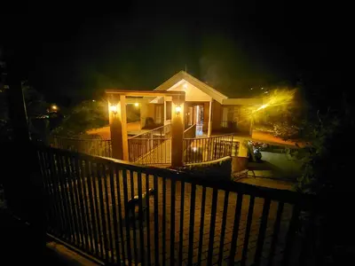 a house with a porch at night with lights at Mi Casa Su Casa Monteverde in Monteverde Costa Rica