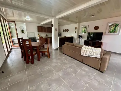 a living room with a couch and a table at La Casa Pina Pacifica near La Fortuna in San Ramón