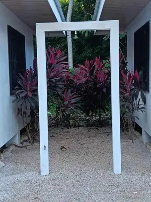 a white frame in front of some plants at Apartamento LAMBERT in Playa Pelada